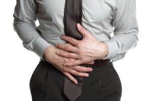 businessman-holding-his-stomach-pain
